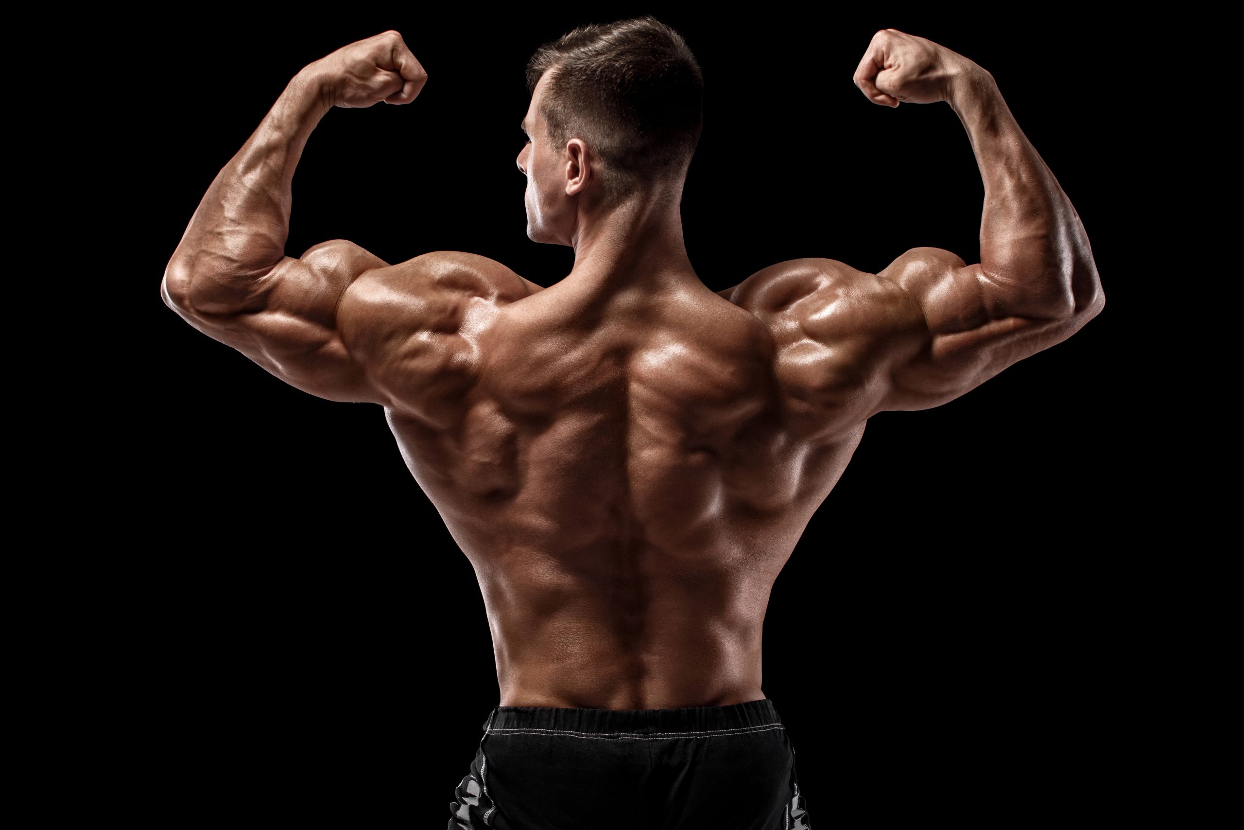 photo of a man flexing his muscles wearing black shorts