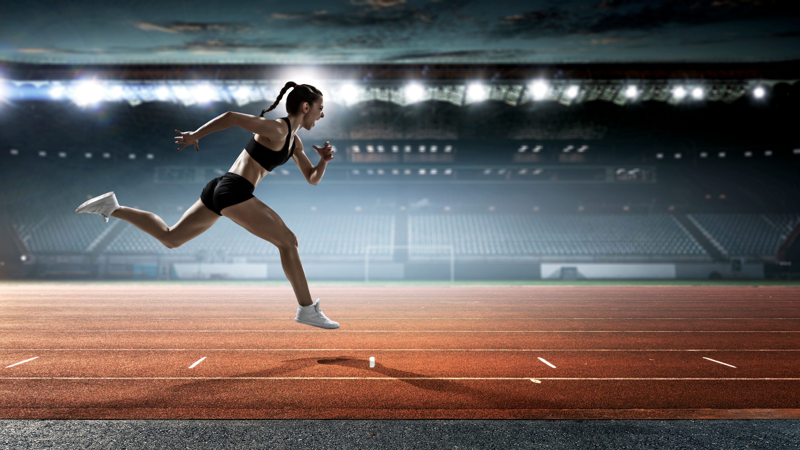 photo of a woman running on a track